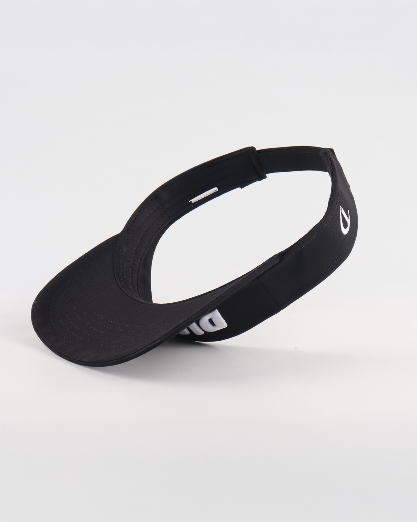 • Close-up of white puff embroidery on black golf visor
• Dialed Golf black visor logo detail