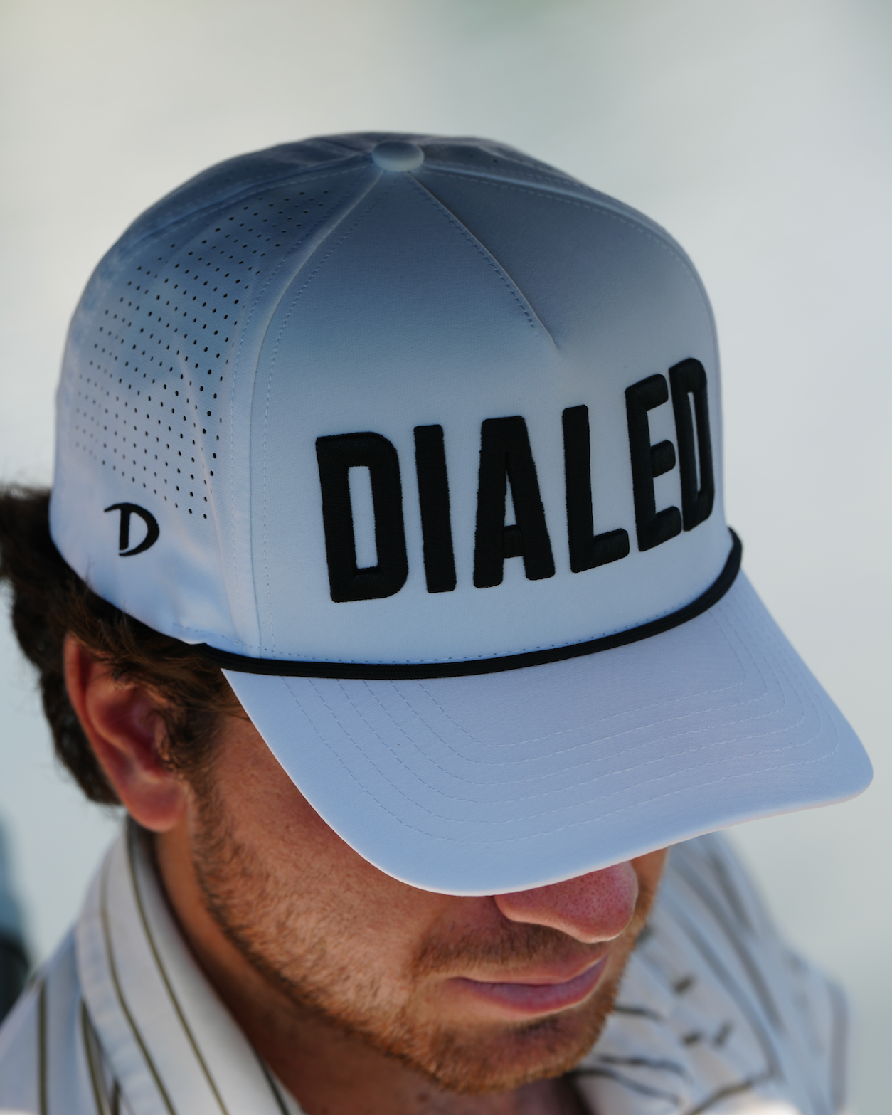Front view of the DIALED white rope hat featuring a clean, structured fit and signature logo.