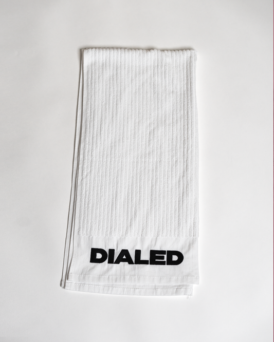 • White golf towel with embroidered Dialed logo
• Dialed Golf white towel front view