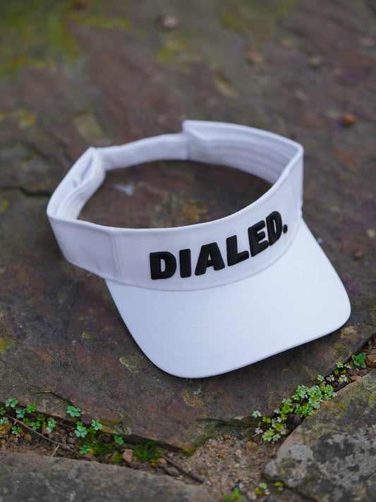 Front view of the Dialed white performance visor featuring our signature raised puff logo for a clean, minimal look.