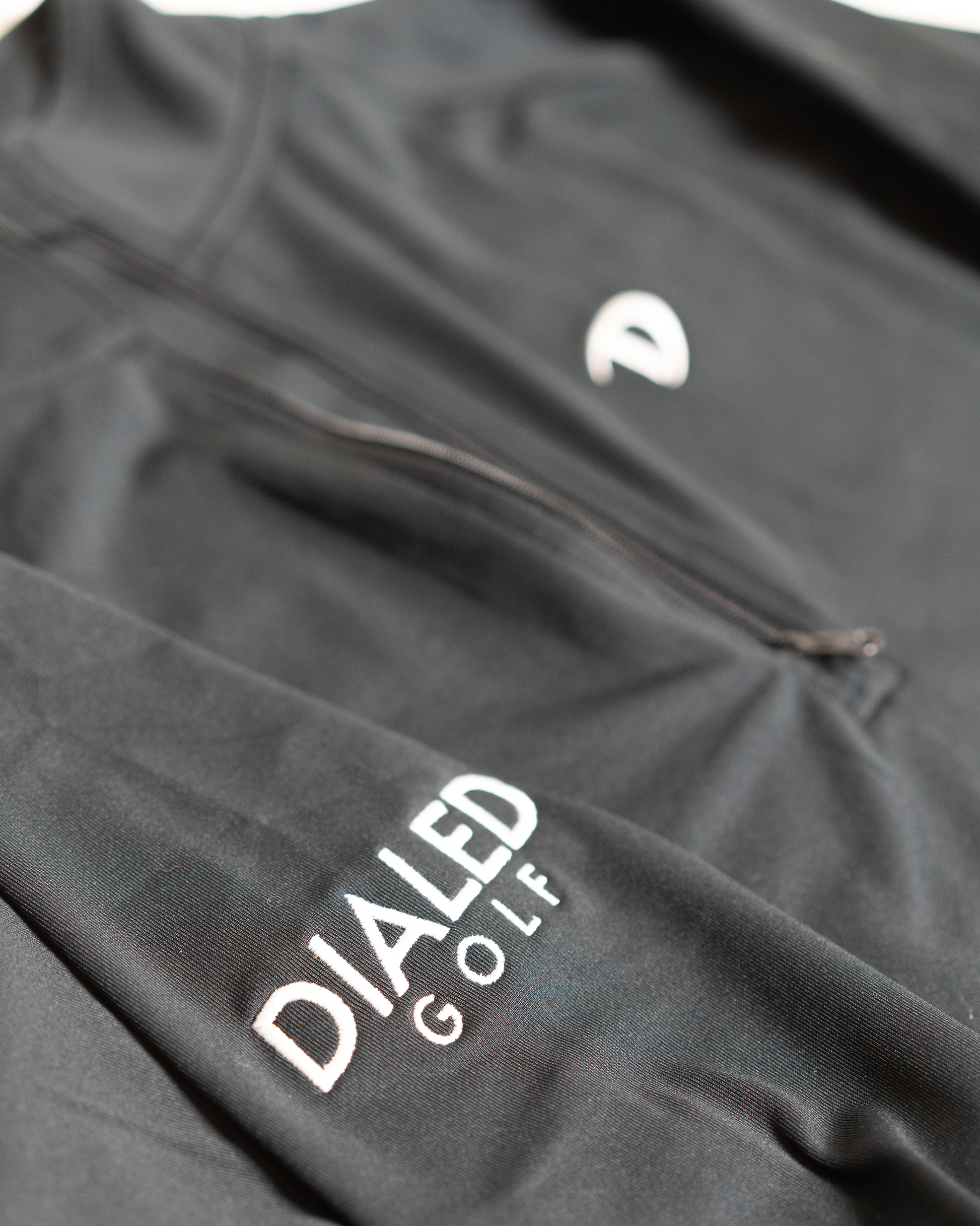 Side angle highlighting the breathable fabric, smooth quarter-zip neckline, and relaxed unisex fit.