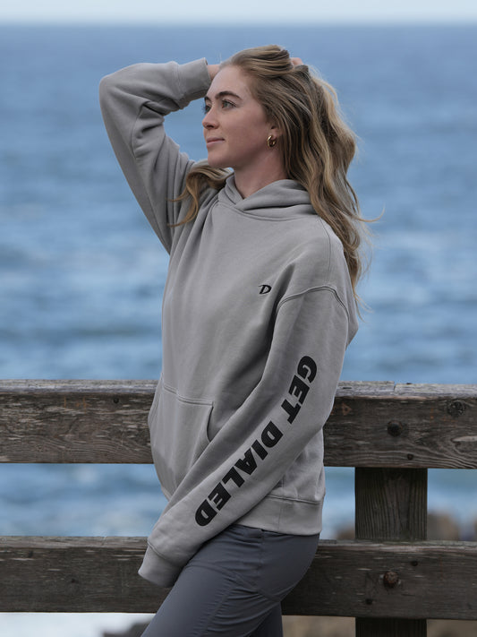 Grace Charis wearing Storm Dialed Golf hoodie side view showing GET DIALED sleeve graphic